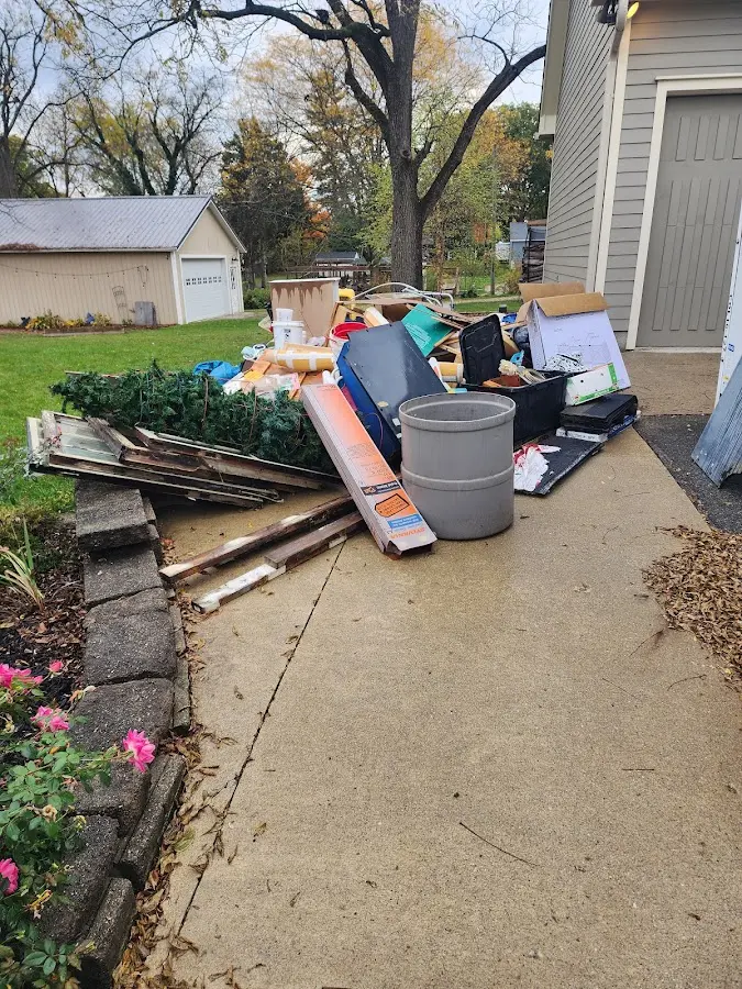 Dumpster being loaded with debris for 12 Yard Dumpster Rental in Aspen Hill